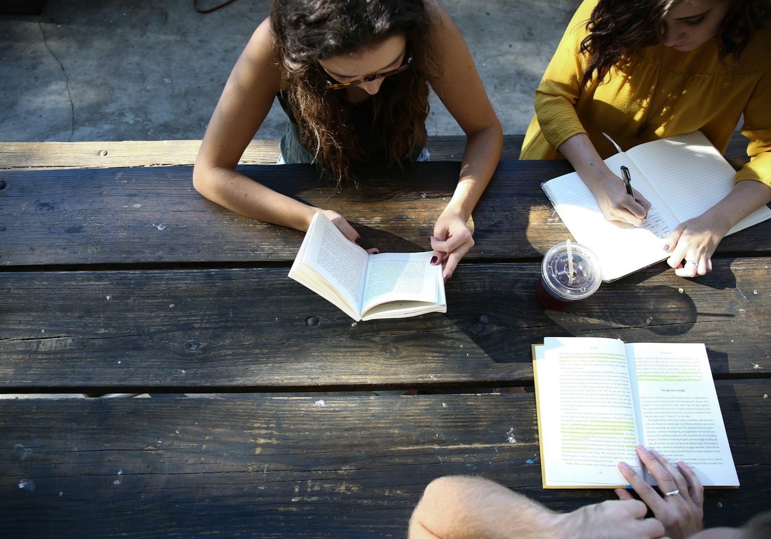 woman reading book while sitting on chair